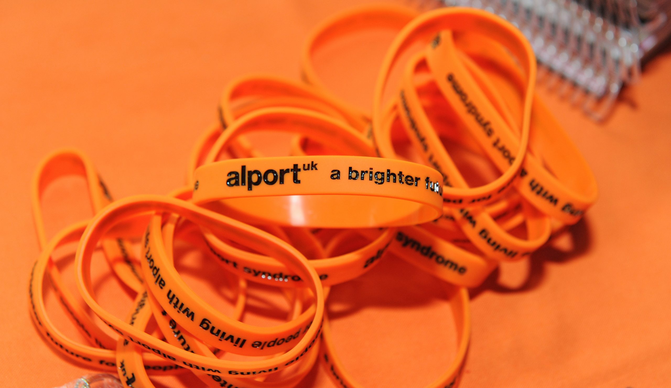 Alport UK orange bracelets.